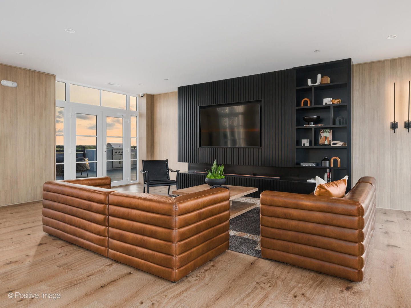 11 West Prospect Avenue, Unit 217 Mount Prospect, IL 60056 - Photo 42 of 66 a living room with furniture a flat screen tv and a floor to ceiling window