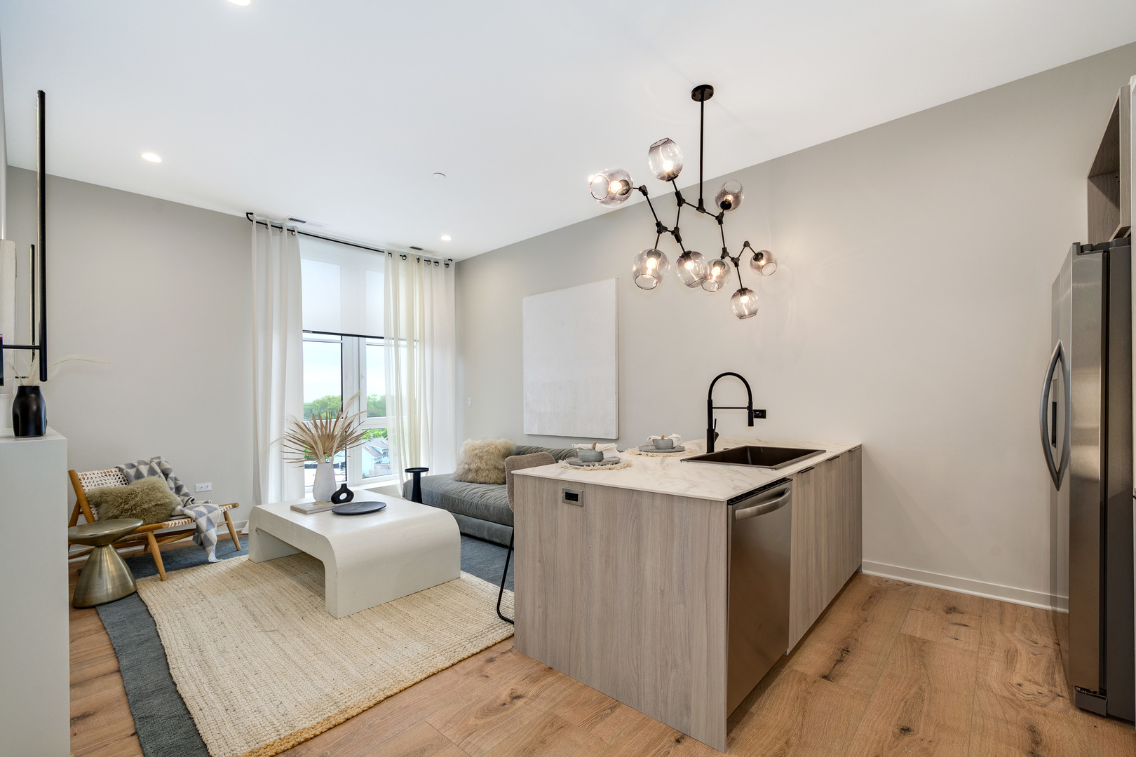 11 West Prospect Avenue, Unit 217 Mount Prospect, IL 60056 - Photo 5 of 66 a living room with stainless steel appliances granite countertop furniture a fireplace and a chandelier