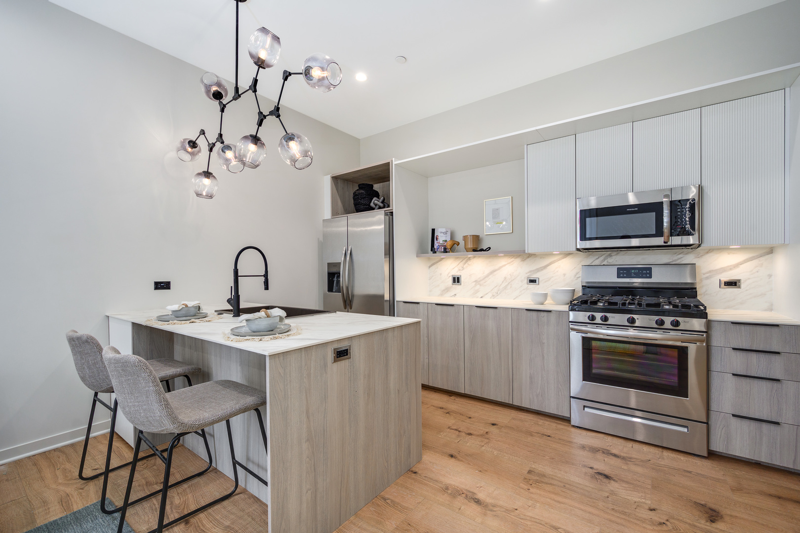 11 West Prospect Avenue, Unit 217 Mount Prospect, IL 60056 - Photo 6 of 66 a kitchen with kitchen island a stove a sink and a refrigerator
