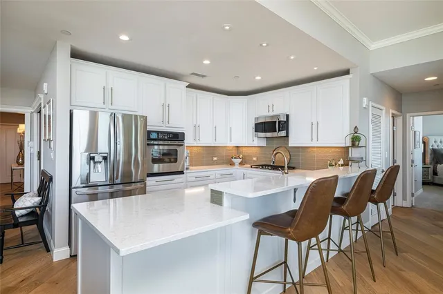 a kitchen with stainless steel appliances granite countertop a sink and cabinets