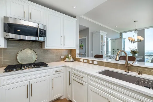 a dining room with furniture a chandelier and wooden floor