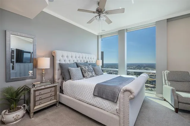 a bedroom with a large bed and a chandelier