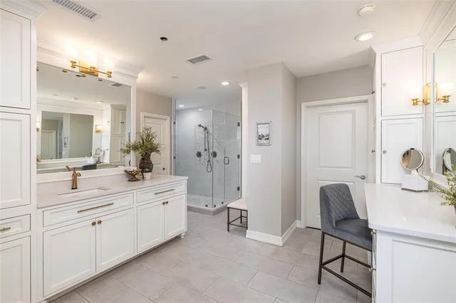 a spacious bathroom with a granite countertop sink mirror and shower