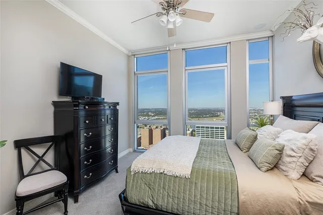 a bedroom with a bed and a chandelier