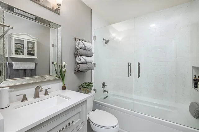 a view of a balcony with wooden chairs and iron fence