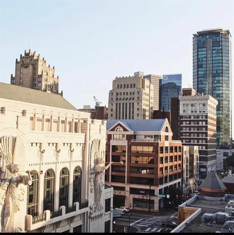 a night stand and potted plants in front of a building