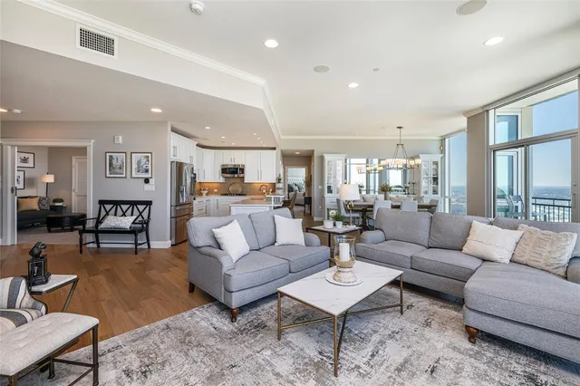 a living room with furniture kitchen view and a table