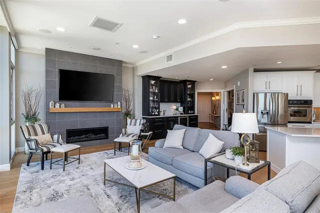 a living room with fireplace furniture and a flat screen tv