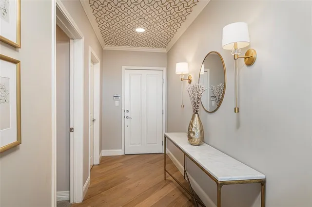 a room with wooden floor and white doors