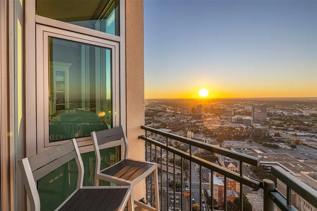 a view of a balcony with chair and wooden floor