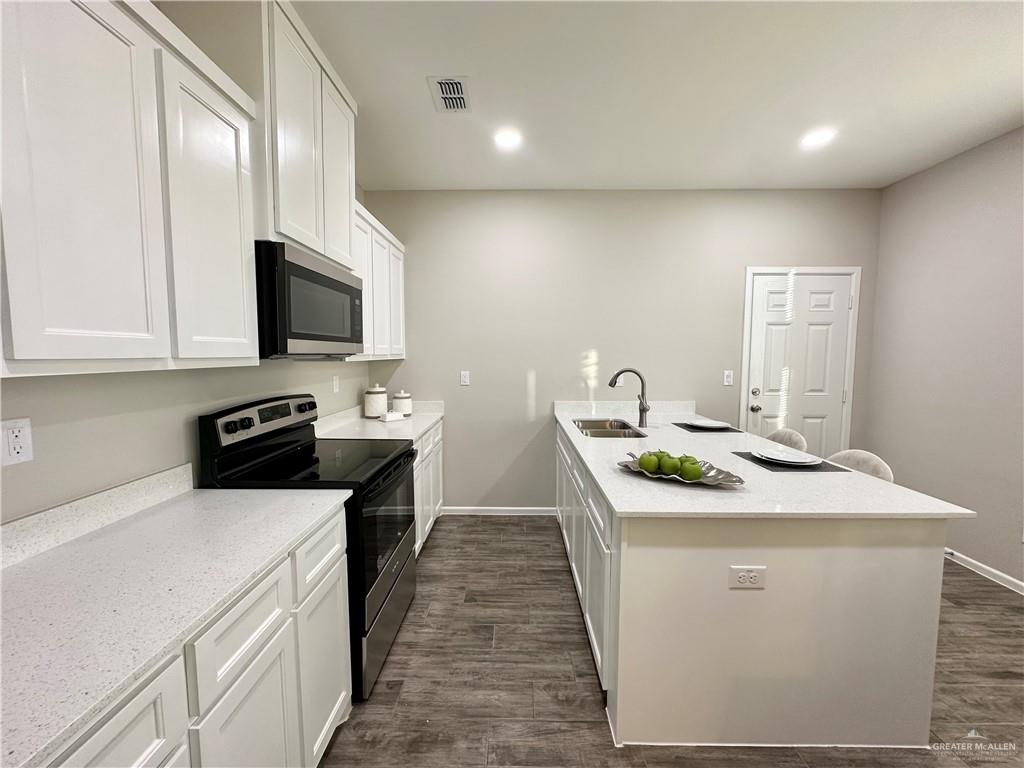 1011 Starr Street Mercedes, TX 78570 - Photo 13 of 35 a kitchen that has a sink and a stove