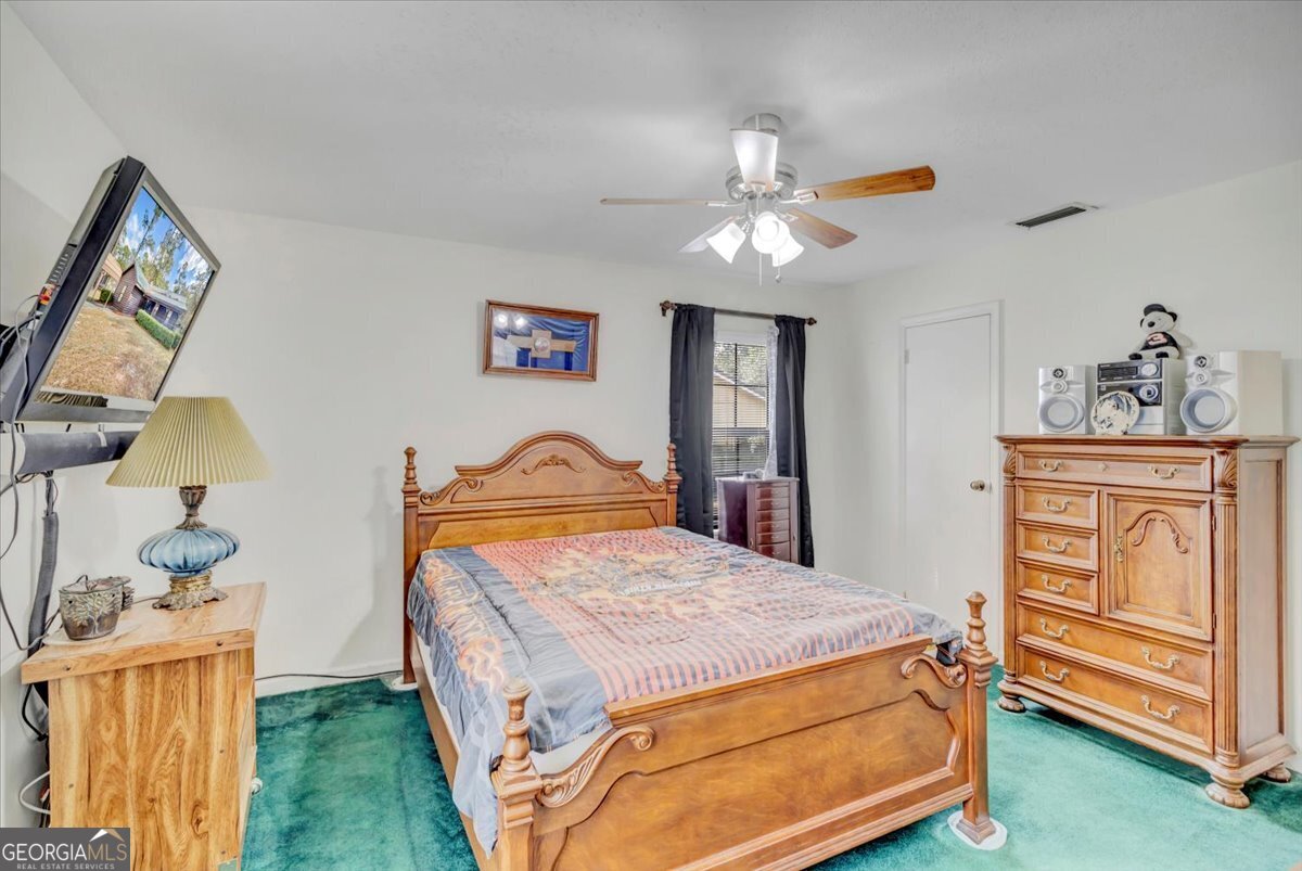 1702 Vada Road Bainbridge, GA 39817 - Photo 12 of 33 a bedroom with a bed and a dresser in it