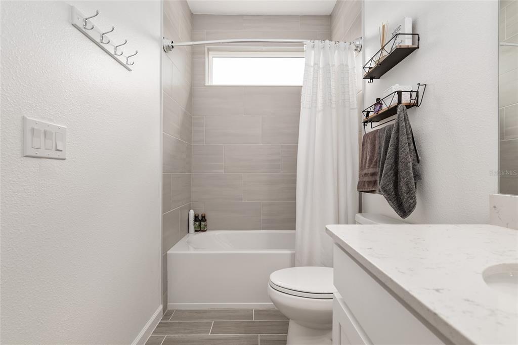 5688 Southwest 92nd Place Ocala, FL 34476 - Photo 43 of 54 a bathroom with a sink a toilet and shower