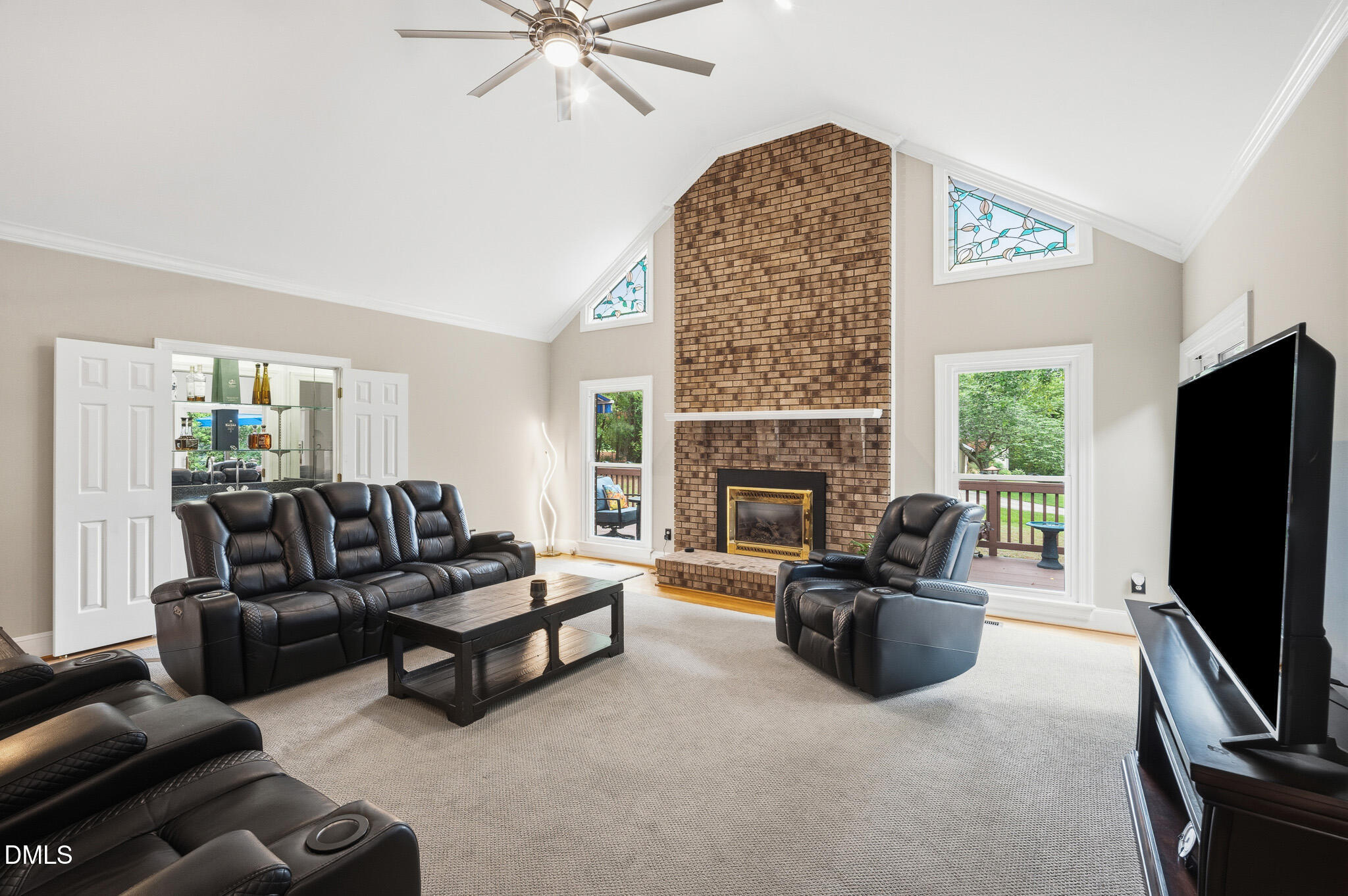 3735 Stoneybrook Drive Durham, NC 27705 - Photo 4 of 44 a living room with furniture flat screen tv and a fireplace