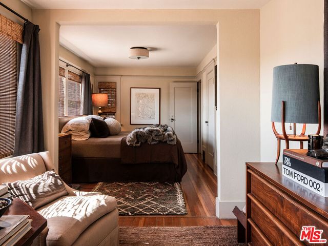 a balcony with wooden floor table and chairs