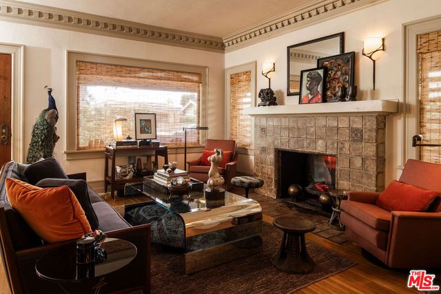 a living room with furniture fireplace and a large window