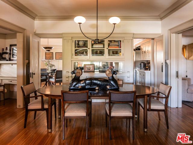 a dining room with furniture and wooden floor