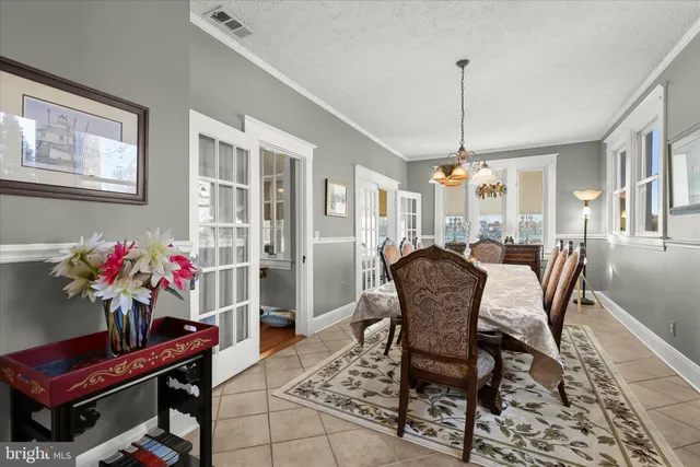 a bedroom with a table chair and a window