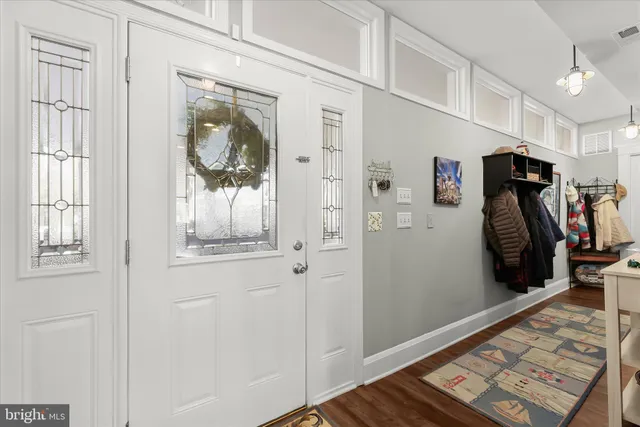 a living room with furniture wooden floor and a large window