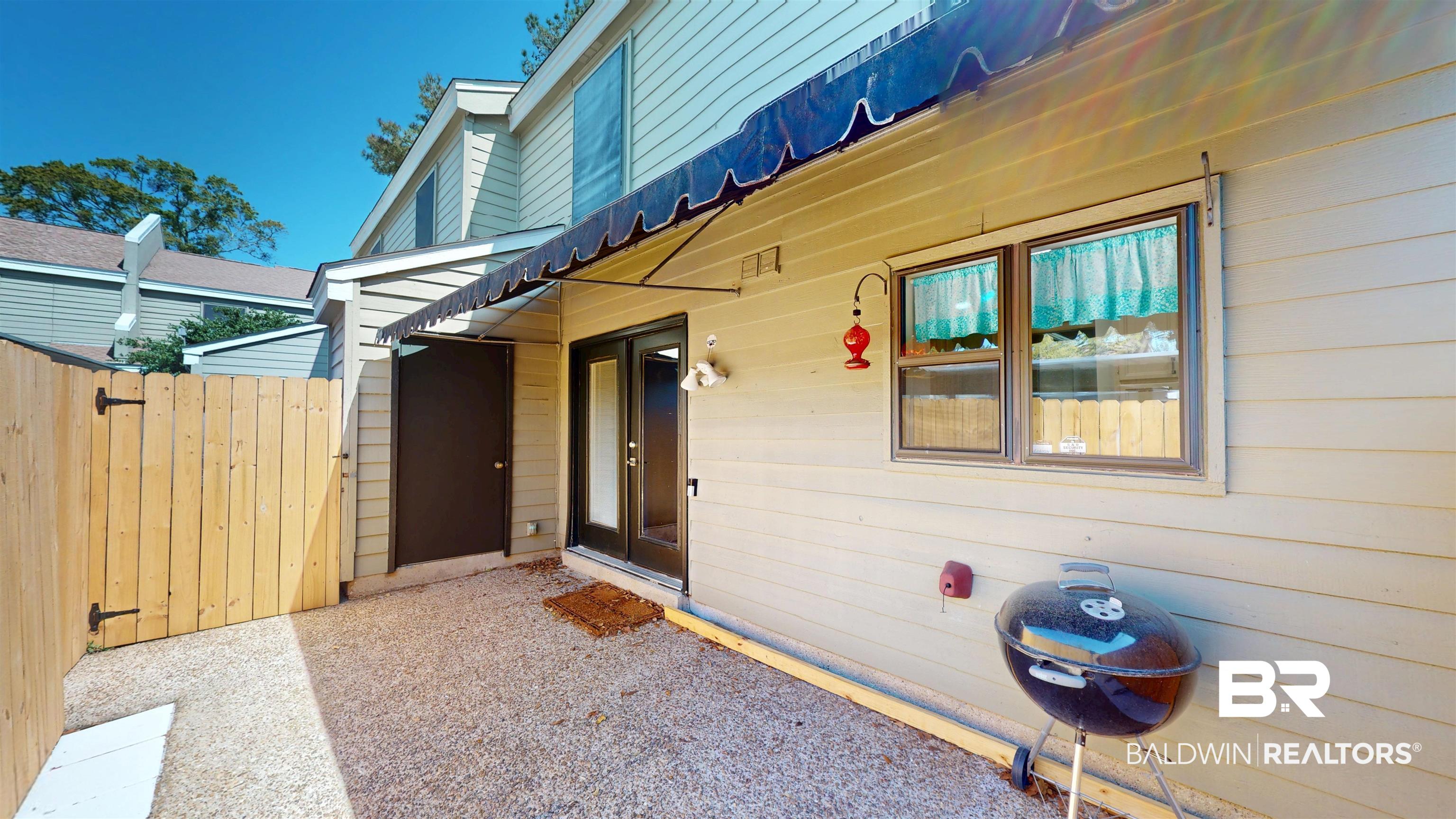 2901 Grant Street, Unit 902 Mobile, AL 36606 - Photo 20 of 35 Doorway to property featuring a patio area and a gate
