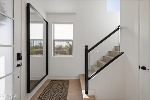 a living room with stainless steel appliances kitchen island granite countertop a stove a sink a refrigerator and white cabinets