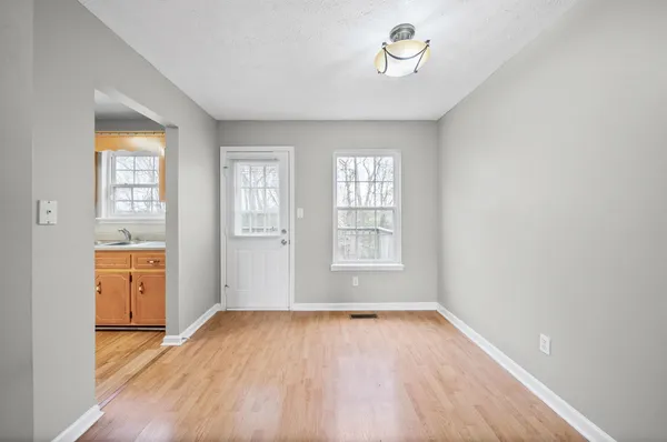 wooden floor in an empty room with a window