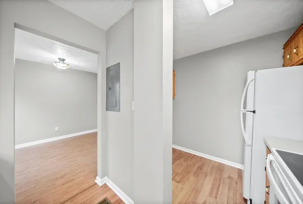 a view of empty room with wooden floor