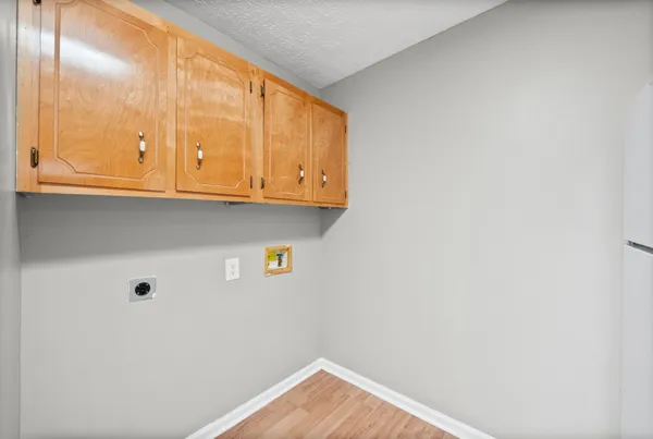a view of storage and utility room with wooden floor