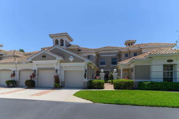 a front view of a house with a garden and yard