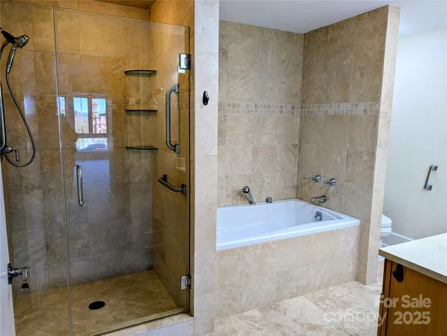 a bathroom with a tub a sink and shower