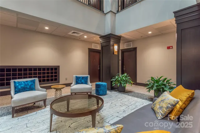 a living room with furniture and a chandelier