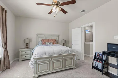 a bedroom with a bed and a tv on the dresser