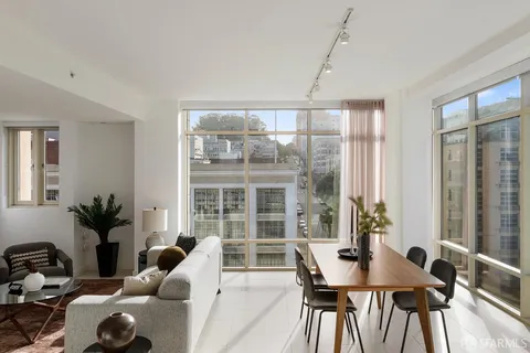 a view of a dining room with furniture and windows