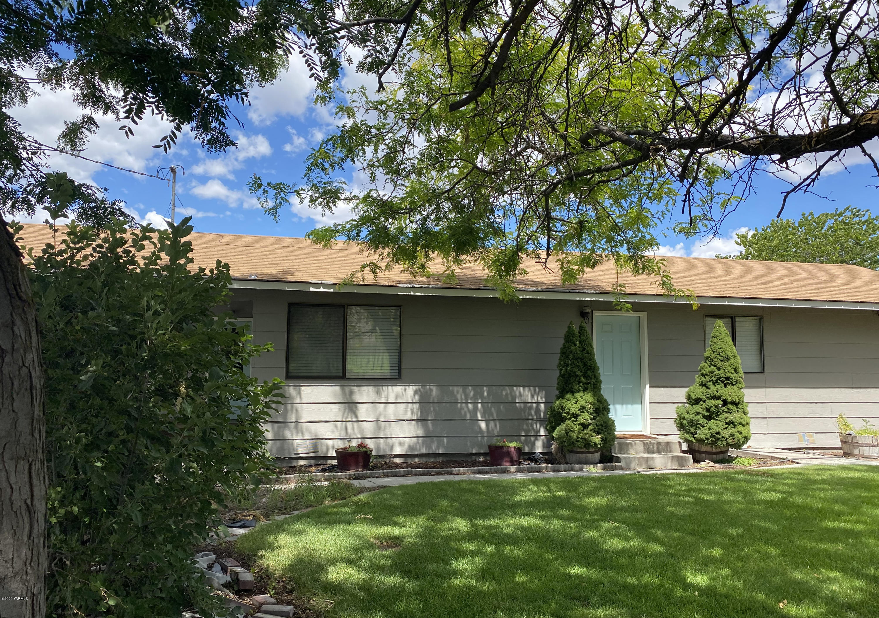 4901 Gamache Road Moxee, WA 98936 - Photo 1 of 1 a front view of a house with a garden