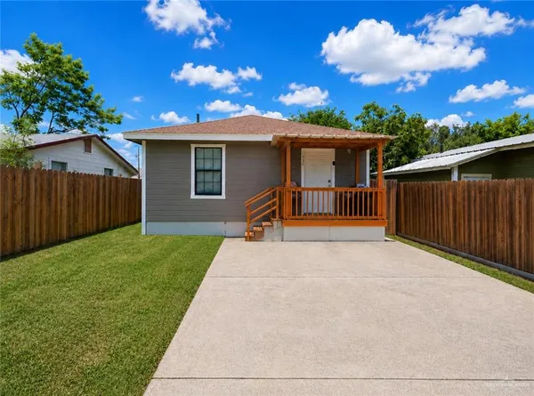 a backyard of a house with wooden fence