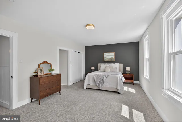 a bedroom with a bed and a lamp