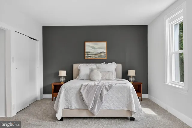 a bedroom with furniture and window