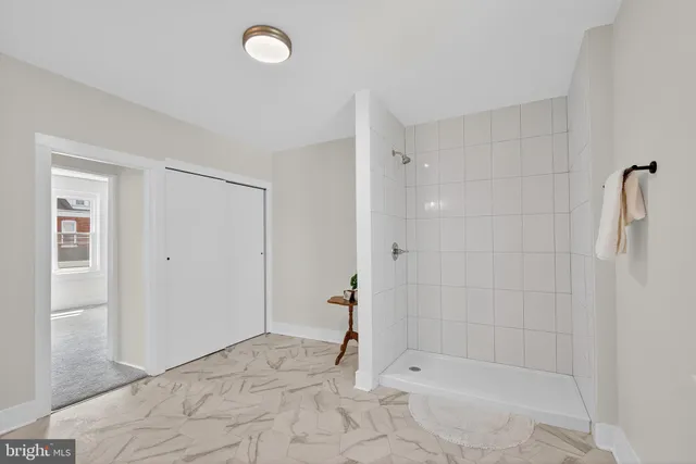 a bathroom with a bathtub shower sink and mirror