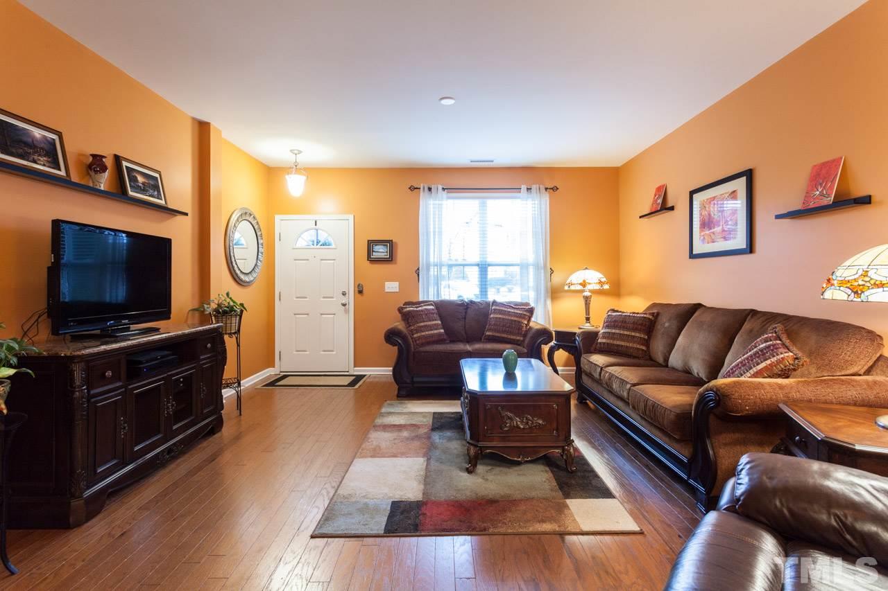 2930 Casona Way Raleigh, NC 27616 - Photo 2 of 25 a living room with furniture and a flat screen tv