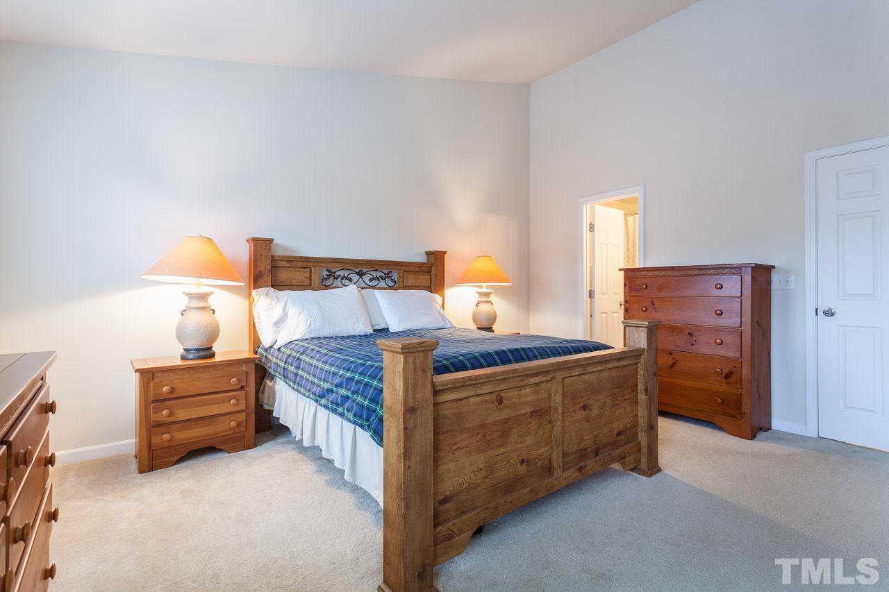 2930 Casona Way Raleigh, NC 27616 - Photo 12 of 25 a bed sitting in a bedroom and dresser