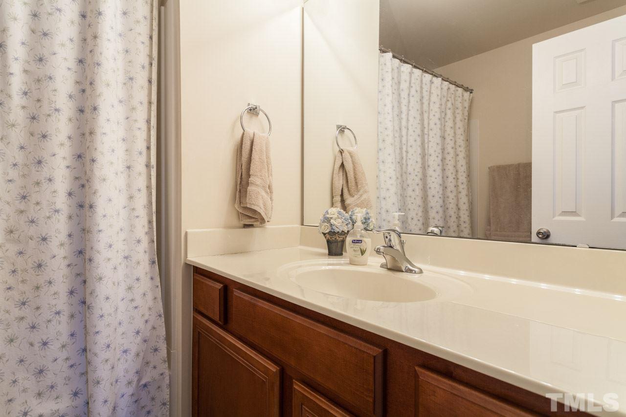 2930 Casona Way Raleigh, NC 27616 - Photo 13 of 25 a bathroom with a sink and a mirror