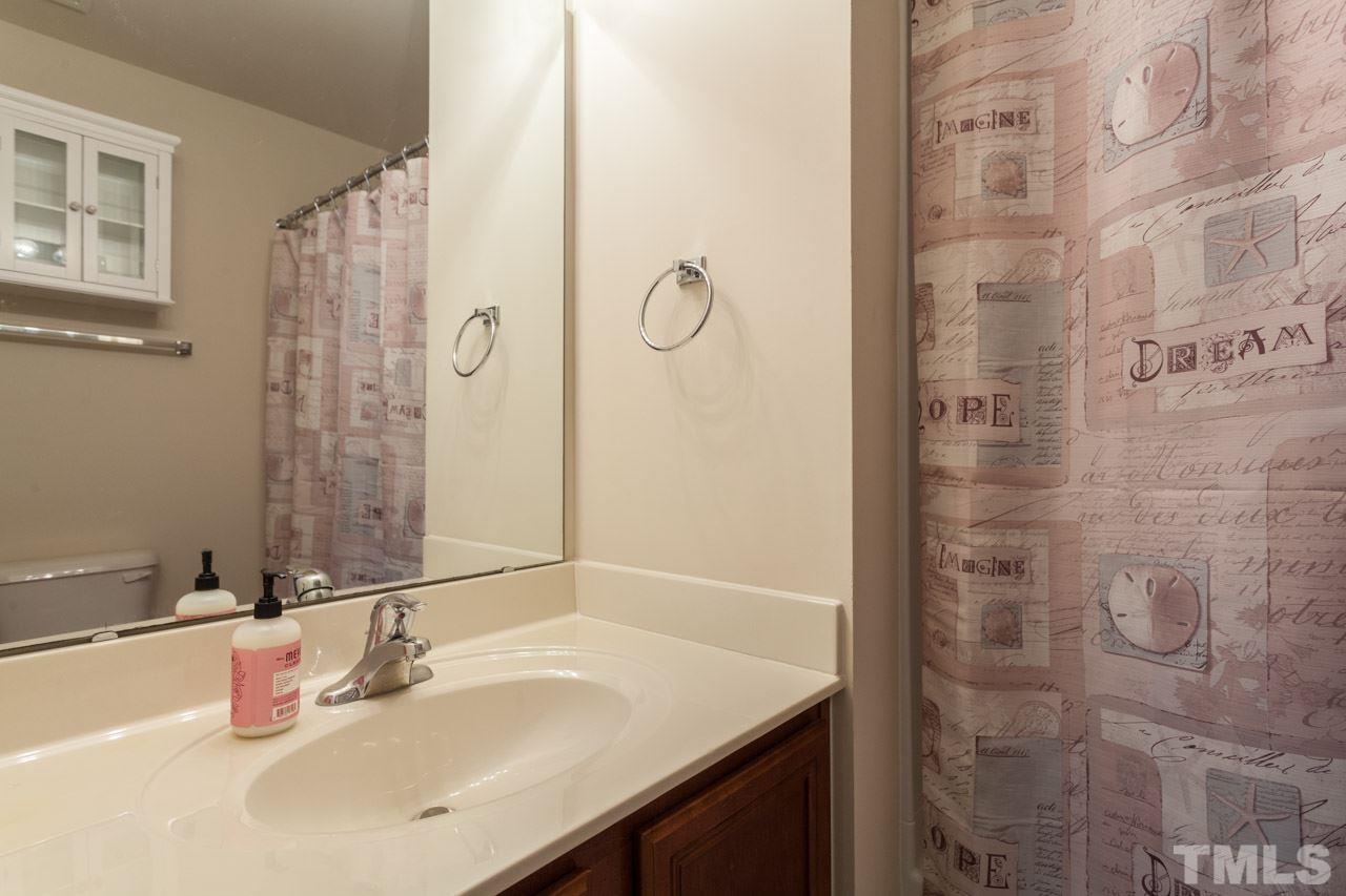 2930 Casona Way Raleigh, NC 27616 - Photo 16 of 25 a bathroom with a sink and a mirror