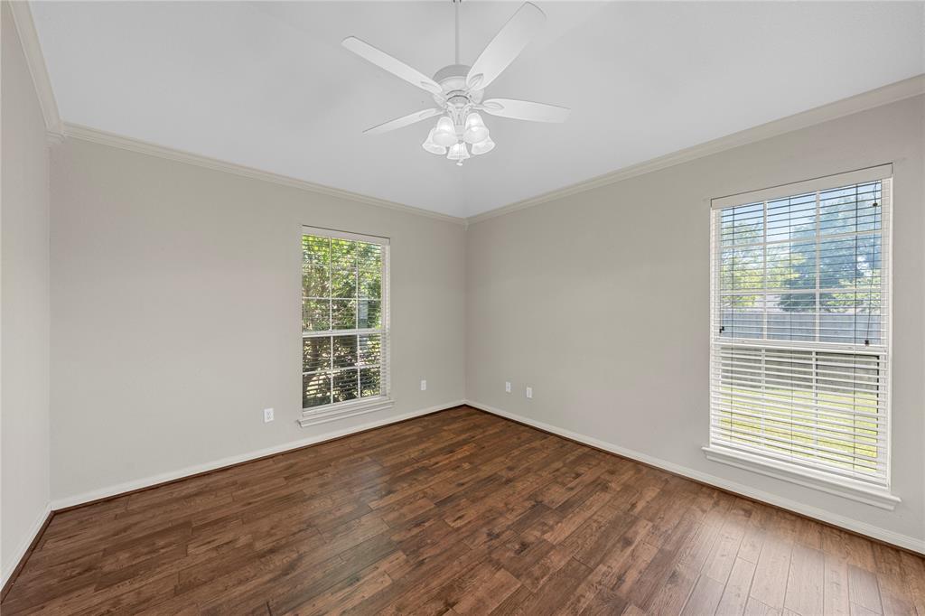 1209 Stonehill Circle Hewitt, TX 76643 - Photo 15 of 24 a view of an empty room with wooden floor and a window