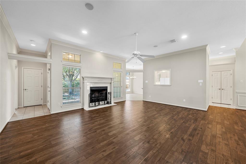 1209 Stonehill Circle Hewitt, TX 76643 - Photo 3 of 24 an empty room with wooden floor fireplace and windows