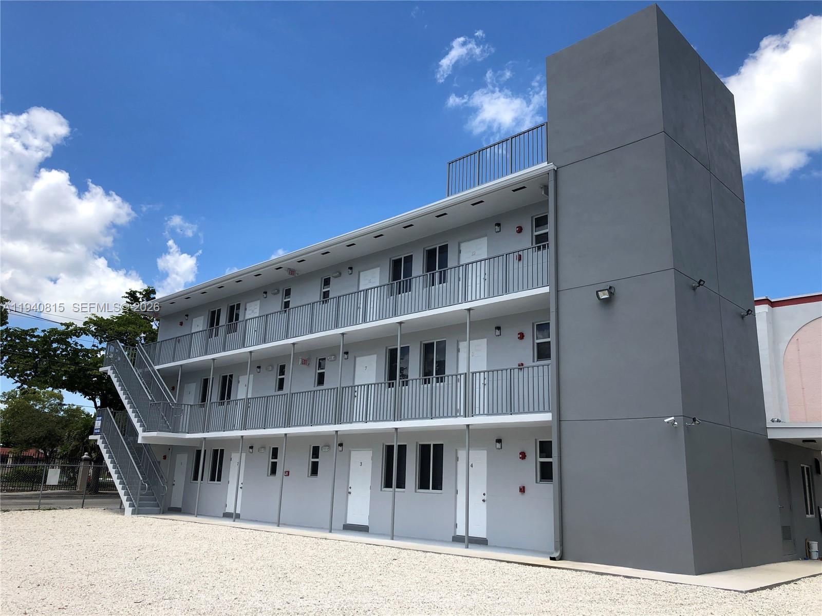 1737 Northwest 3rd Avenue, Unit 7 Miami, FL 33136 - Photo 2 of 9 a large building with a large windows