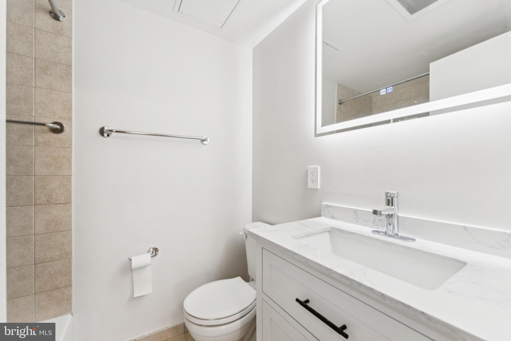 800 4th Street Southwest, Unit S418 Washington, DC 20024 - Photo 14 of 22 a bathroom with a sink a toilet and shower