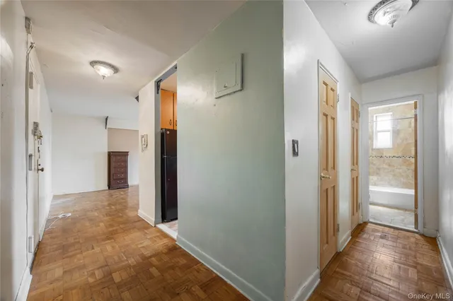 a view of hallway with wooden floor