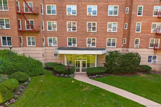 a large brick building with a yard in front of it
