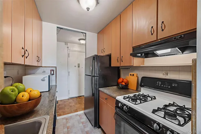 a kitchen with stainless steel appliances granite countertop a stove and a refrigerator