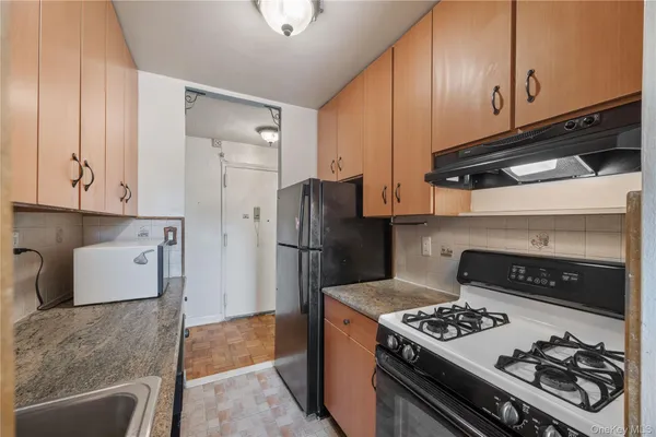 a kitchen with refrigerator and stove